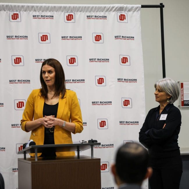 Two prominent women in construction - WMCI President Jen Schottke and Grand Rapids Literacy Executive Director Wendy Falb - speak at a WMCI event