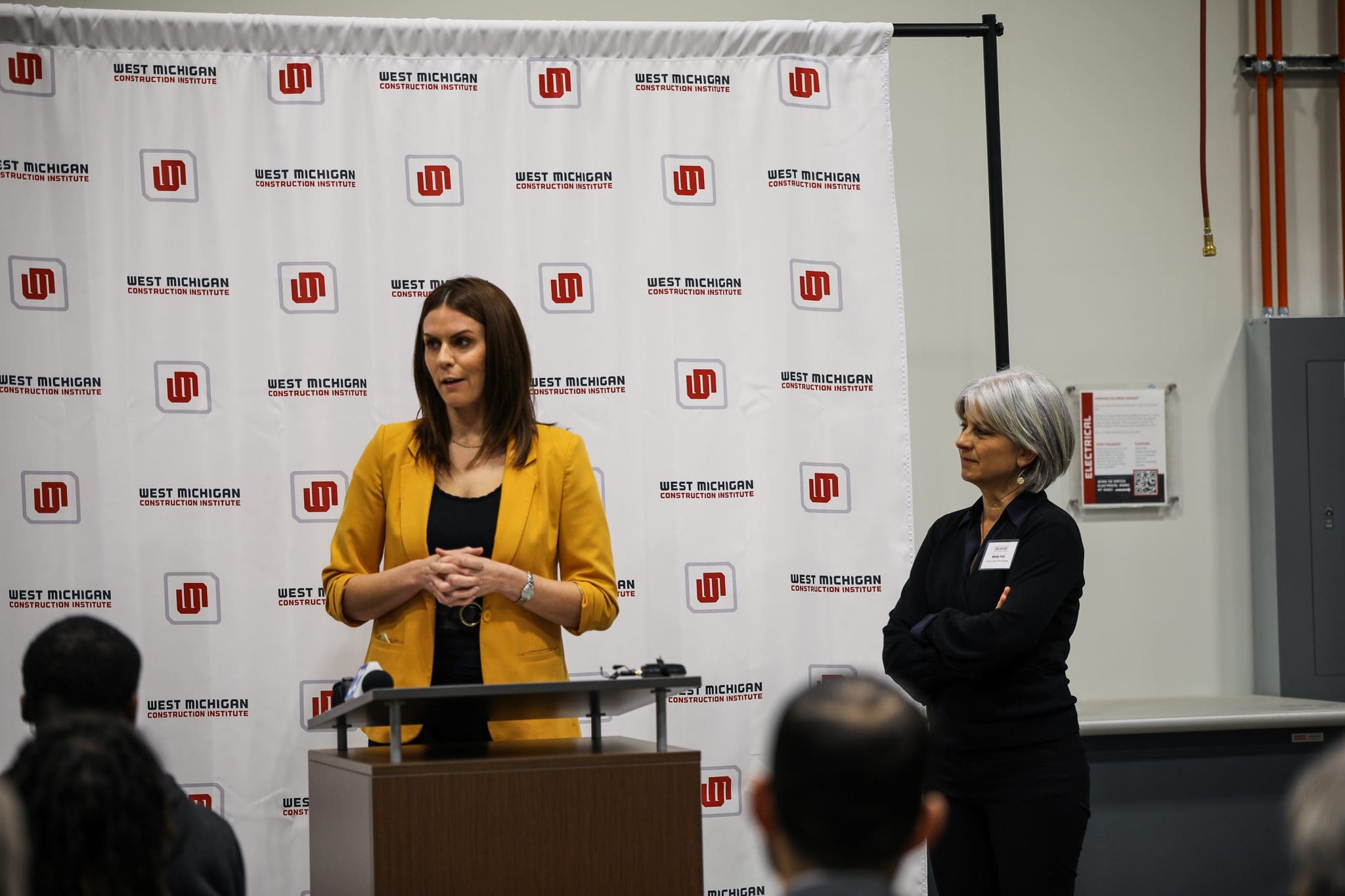 Two prominent women in construction - WMCI President Jen Schottke and Grand Rapids Literacy Executive Director Wendy Falb - speak at a WMCI event