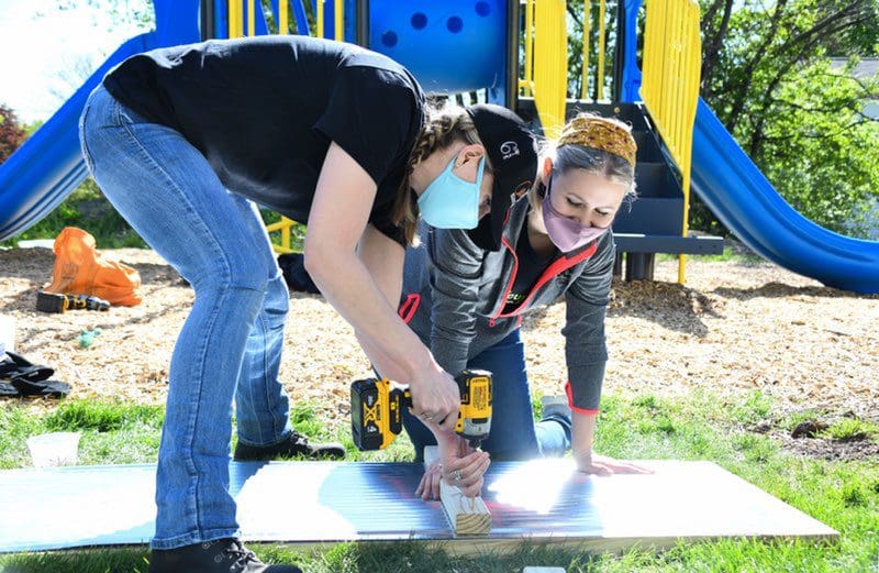 Jasmin volunteering by helping build solar panels