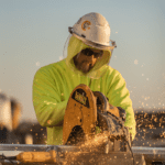 Carpenter sawing wood with power tool