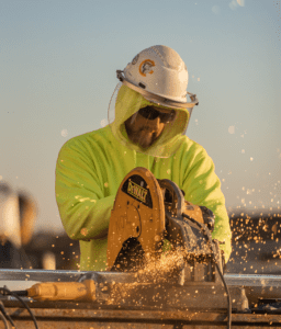 Carpenter sawing wood with power tool