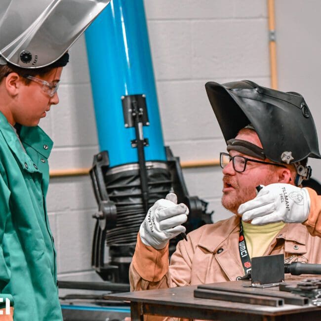 A West Michigan Construction Institute student learns the basics of welding from an instructor