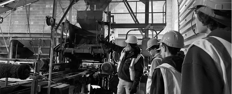 A WMCI instructor takes a group of high school construction students on a tour of a jobsite.
