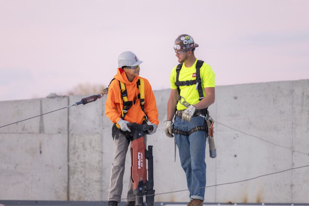 A WMCI student learns concrete skills on a job site visit to the construction site of Grand Rapid's Amphitheater project.