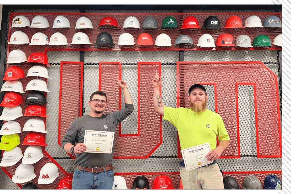 WMCI Construction Training Scholarship recipients pose in front of the WMCI hard hat wall.