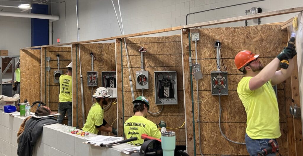 Students in WMCI's electrical program working on electrical boxes in the institute's construction lab.